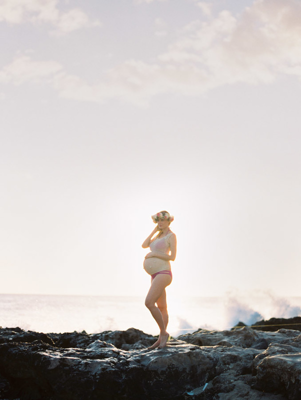 pregnant by the sea standing on lava rocks in Hawaii